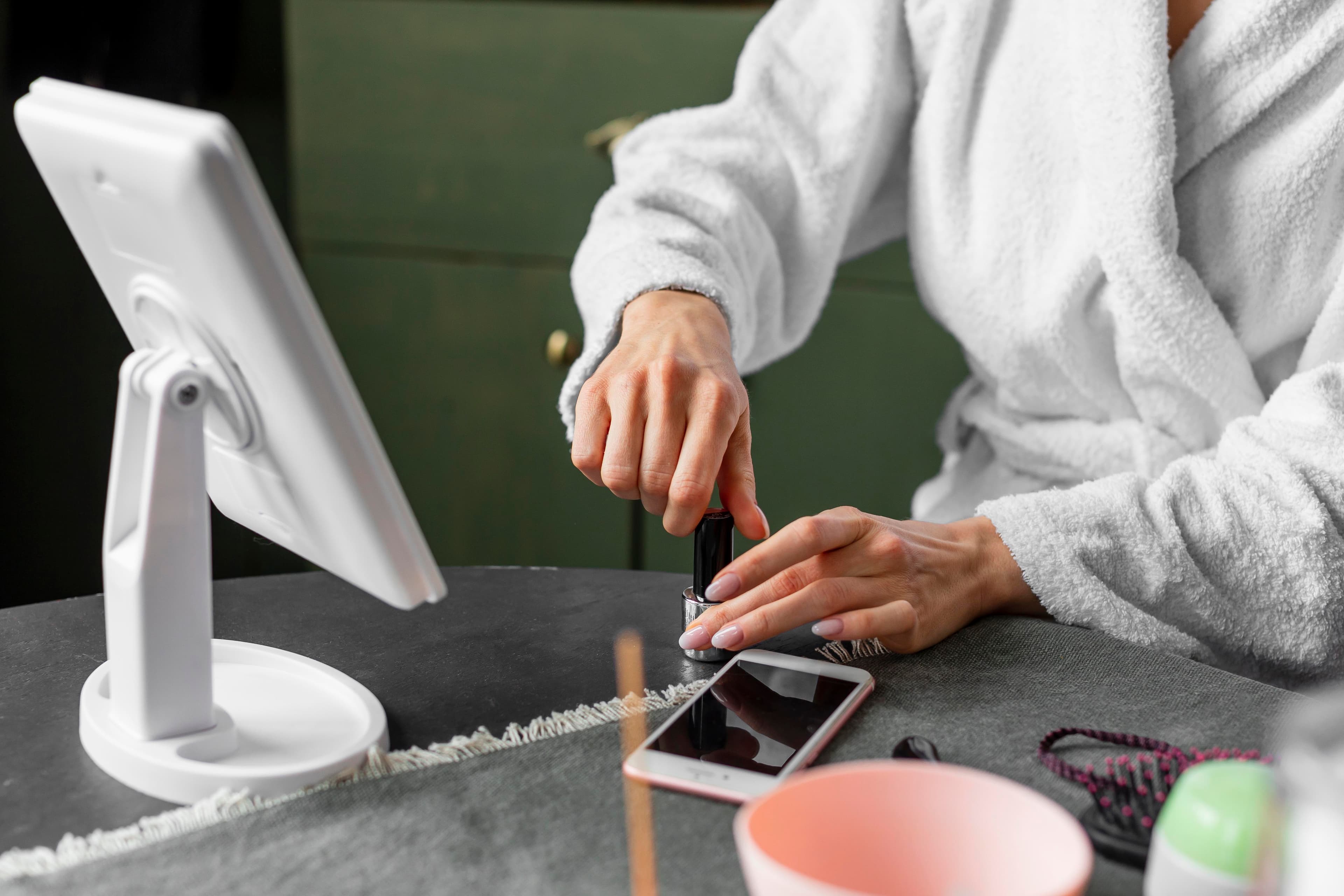 Technician applying manicure with vibrant palette
